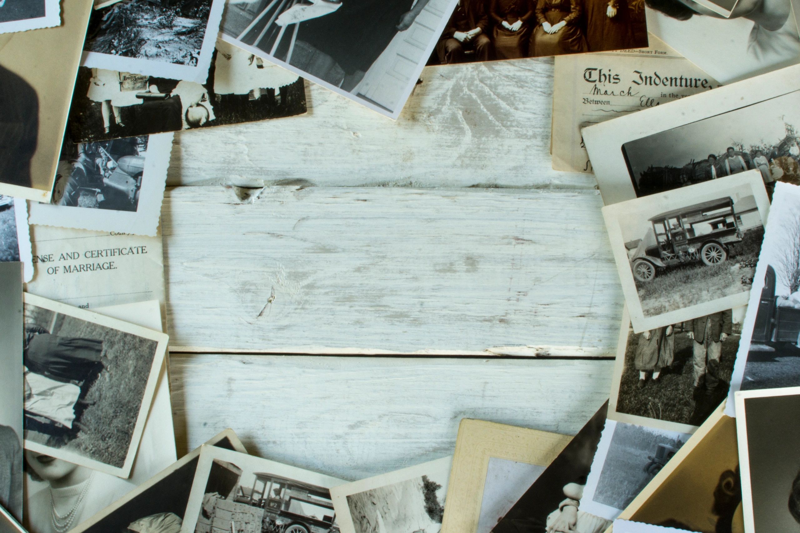 Old family photographs and documents laid out for archiving